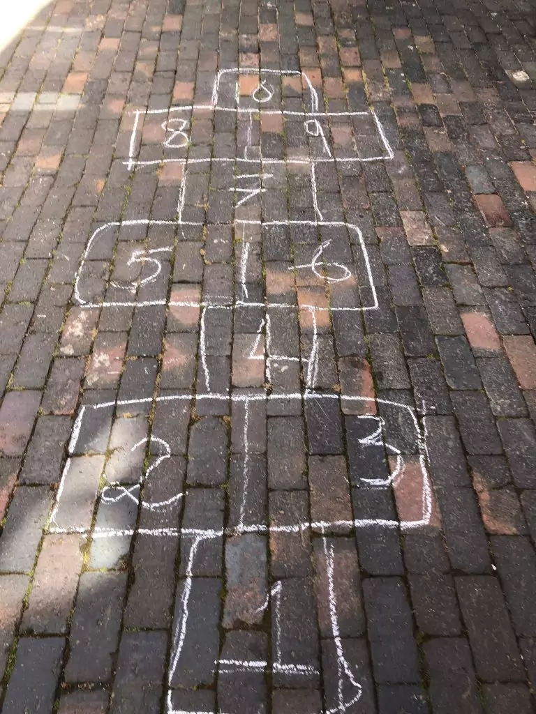 Hopscotch chalked on a brick path
